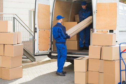 Moving team handling boxes safely during a Docklands van service