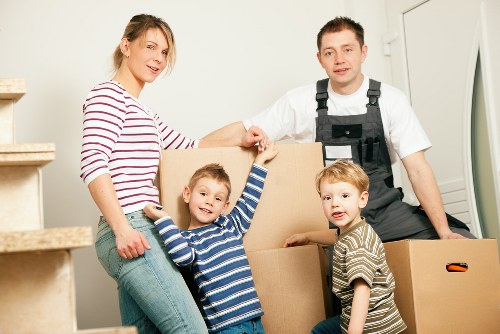 Furniture removal team handling bulky items in a Docklands apartment building