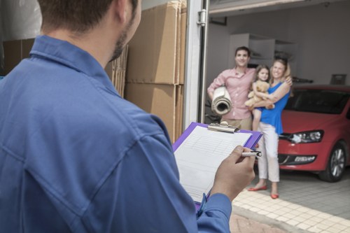 Trained movers carrying furniture with care in a Docklands property