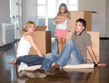Professional movers loading items near a Docklands apartment building